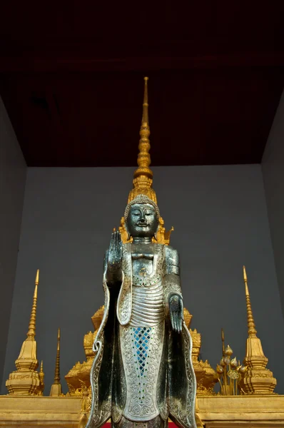 The metal standing Buddha with golden pagoda in the temple in Th — Stock Photo, Image