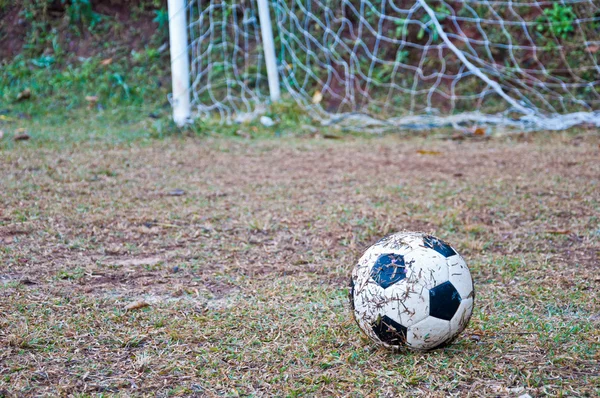 The old football on the grass — Stock Photo, Image