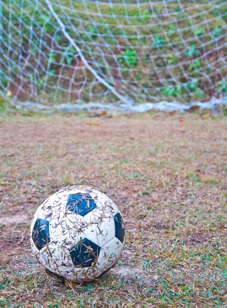 The old football on the grass — Stock Photo, Image
