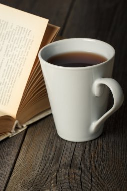 eski açık kitap üzerine ahşap masa ile çay