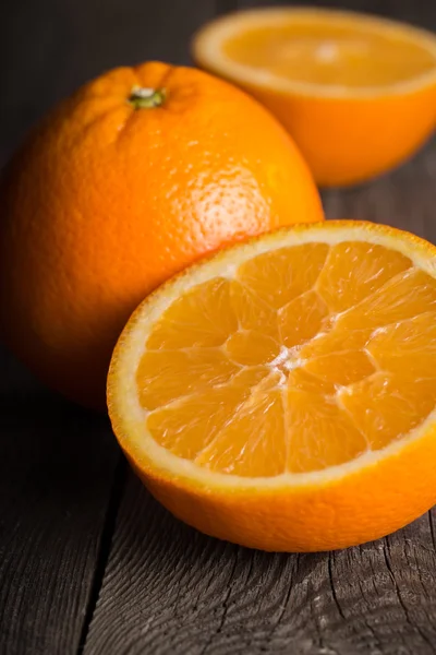 Primer plano de fruta naranja sobre tabla de madera. Centrado en el centro de la parte delantera de color naranja — Foto de Stock