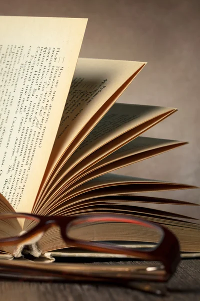 Glasses with old opened book. — Stock Photo, Image