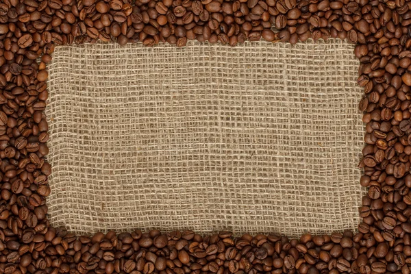 Coffee bean frame on burlap pattern — Stock Photo, Image