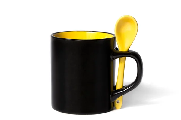 Black mug with spoon — Stock Photo, Image