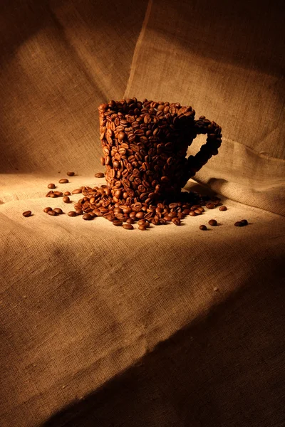 Image of mug covered with coffee beans — Stock Photo, Image