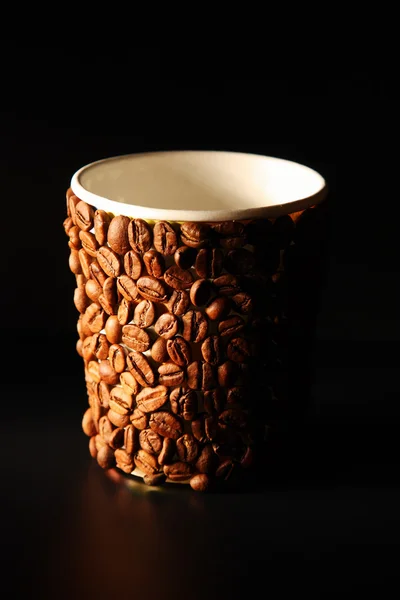 Paper cup covered with coffee beans — Stock Photo, Image