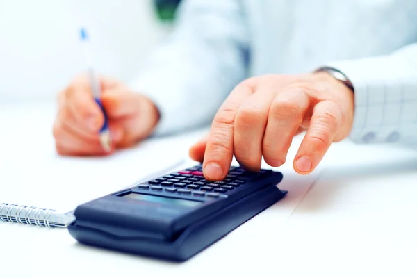Closeup of a businessman calculating — Stock Photo, Image