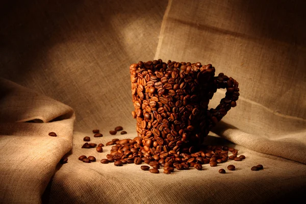 Image of mug covered with coffee beans — Stock Photo, Image