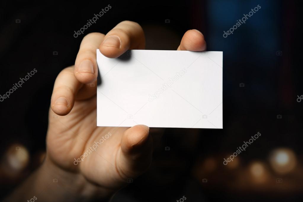 Man holding business card. Close up shot