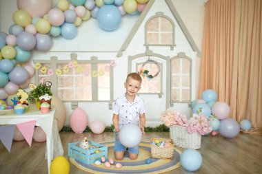 happy easter. happy funny boy playing with Easter objects.