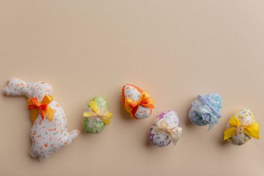Decorated Easter eggs with colored bows on a light background. Easter background.