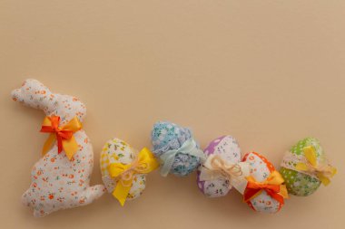 Decorated Easter eggs with colored bows on a light background. Easter background.
