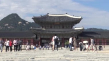Güney Kore 'deki Gyeongbokgung Sarayı girişindeki Geunjeong Jeon salonunu ziyaret eden turistlerin dikkatsiz görüntüleri. Sahnede bulanık arkaplan