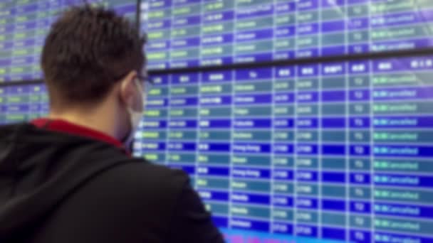 Blurred Defocused Caurcasian Man Looking Airport Board Cancelled Planes Wearing — Stock videók