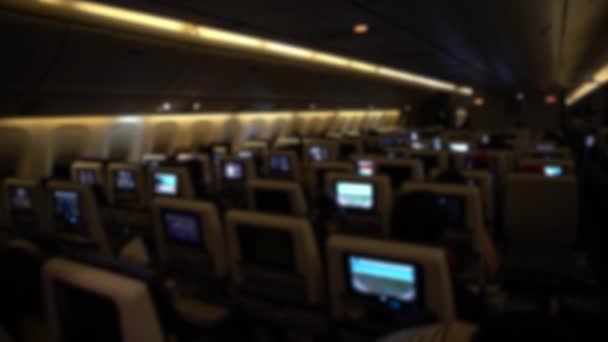 Defocused Shot Traveling Air Airplane Cabin Passengers Looking Monitors Movies — Vídeo de Stock