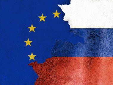 Hasarlı duvar dokusu ve arka plan üzerine Avrupa Birliği ve Rusya bayrakları. Rus kasabasının dışındaki terk edilmiş sanayi binasında uzun taş çatlaklı Avrupa afişi..