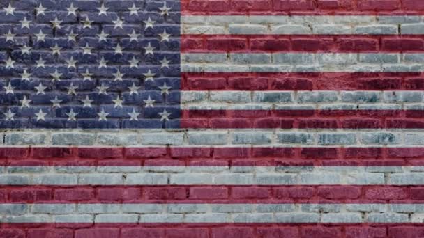 街のレンガの壁の背景にアメリカの旗 アメリカのバナーと外観古い石レンガのテクスチャ 国際外交概念 — ストック動画