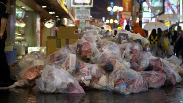 日本大阪 2019年4月14日 在Dotonbori的人行道上堆满了垃圾 旁边是餐厅 城市街道上的垃圾 用于有区别的废物收集的透明垃圾袋 — 图库视频影像