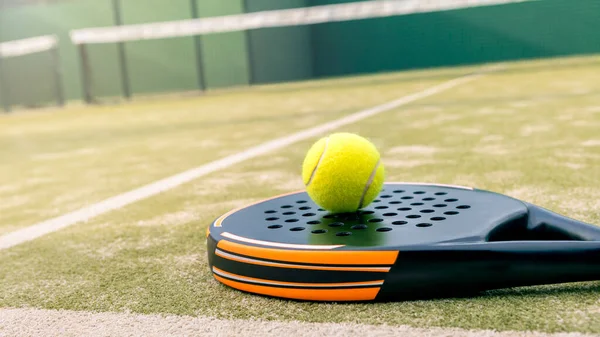 Yellow Ball Padel Tennis Racket Green Court Outdoors Natural Lighting Stockfoto