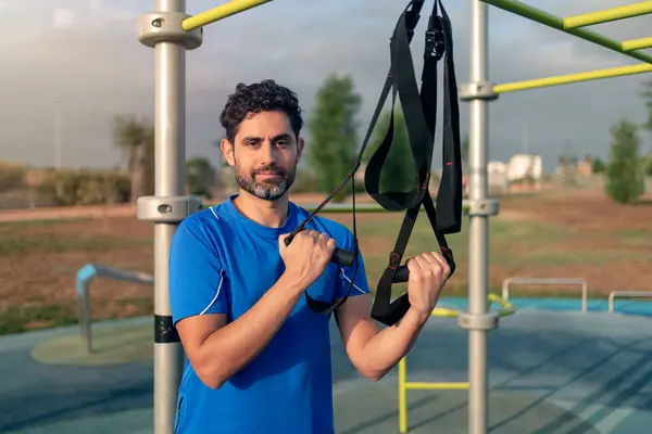 Portrait Confident Young Man Doing Fitness Exercises Special Hanging Device — стоковое фото