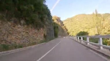 Timelapse driving a car on empty regional road through the fields outside the city during sunny day in Spain. Countryside asphalt road landscape scene. Traveling concept