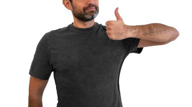 Mockup of blank T-shirt men. Happy male guy showing thumbs up and smiling broadly, giving positive feedback, sharing his positive opinion over white wall. Layout mock up ready for your logo.
