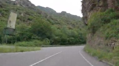 Timelapse driving a car on empty regional road through the fields outside the city during sunny day in Spain. Countryside asphalt road landscape scene. Traveling concept