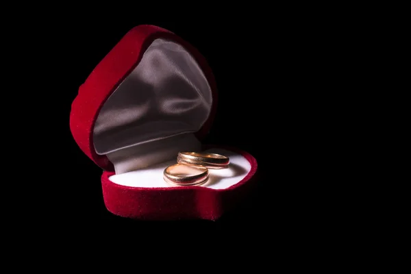 Wedding rings in a box in the shape of heart — Stock Photo, Image
