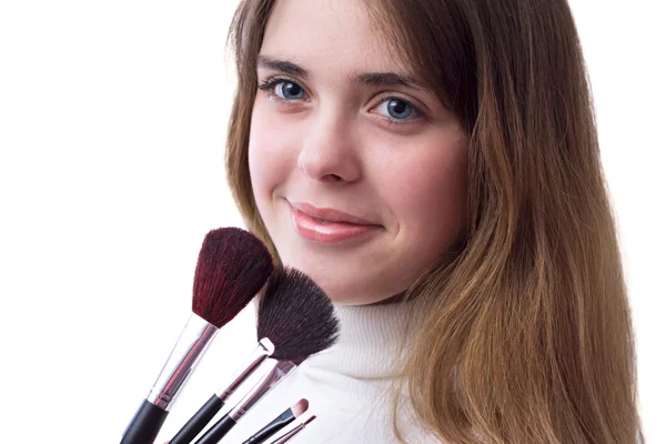 Beautiful girl with a set of brushes for makeup in her hands — Stock Photo, Image