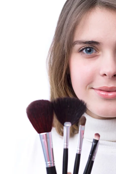 Beautiful girl with a set of brushes for makeup in her hands — Stock Photo, Image