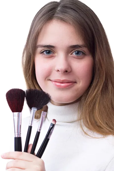 Beautiful girl with a set of brushes for makeup in her hands — Stock Photo, Image