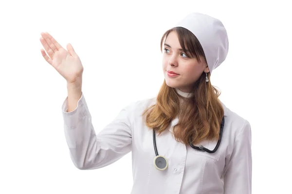 Young doctor with phonendoscope shows at something — Stock Photo, Image