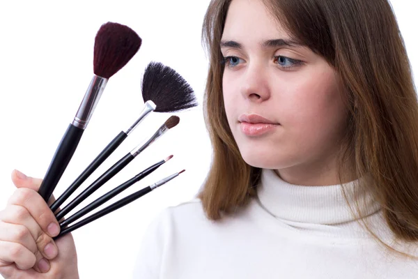 Beautiful girl with a set of brushes for makeup in her hands — Stock Photo, Image