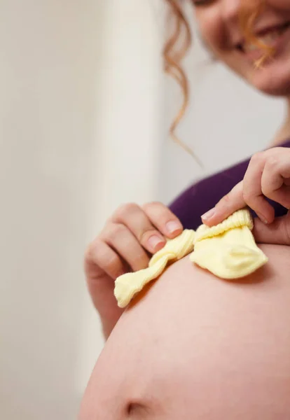 Jovem Bela Mãe Expectante Coloca Meias Criança Pequena Sua Barriga — Fotografia de Stock