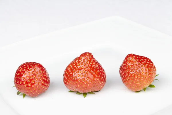 Trois fraises sur une assiette — Photo