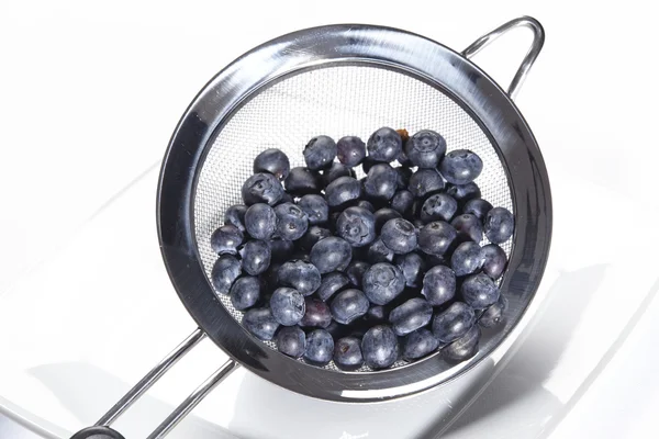 Blueberries into a colander — Stock Photo, Image