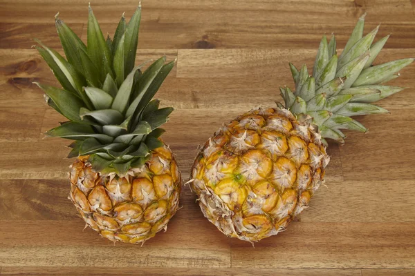 Pineapple on a table of acacia wood — Stock Photo, Image