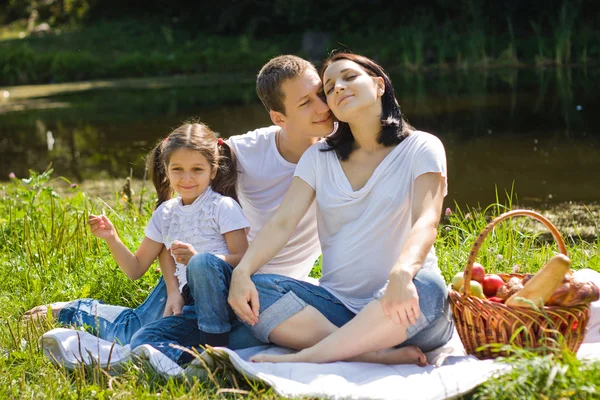 Family picnic near lake — Stock Photo, Image