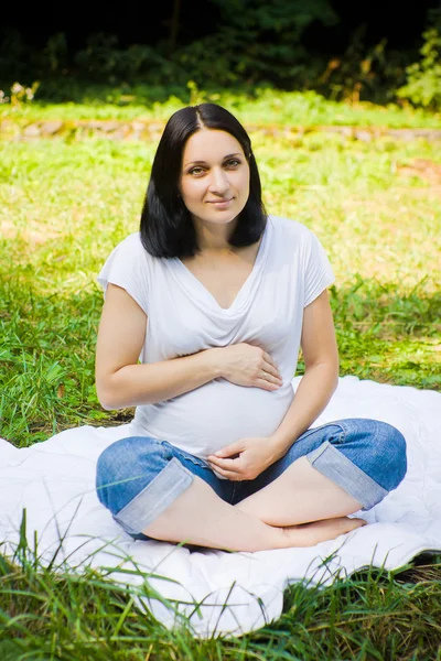 Pregnant woman on a meadow — Stock Photo, Image