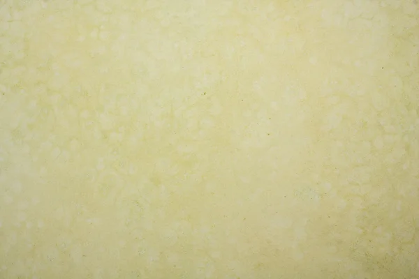 Papel texturizado amarelo sujo — Fotografia de Stock