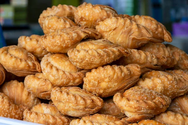 Malaysian deep fried curry puff or epok-epok isolated on white background with clipping path. Curry puff or epok-epok is Asian traditional snacks that has crispy shell. Thai crispy curry puff concept.