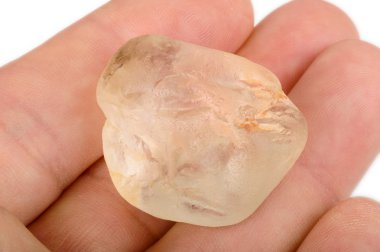 Raw topaz in hand clipart