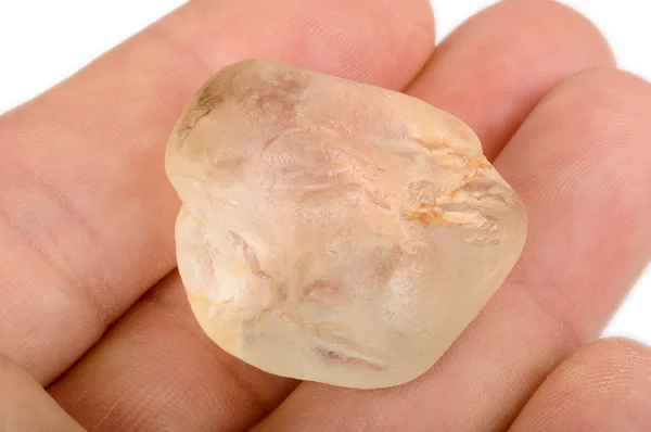 Raw topaz in hand — Stock Photo, Image