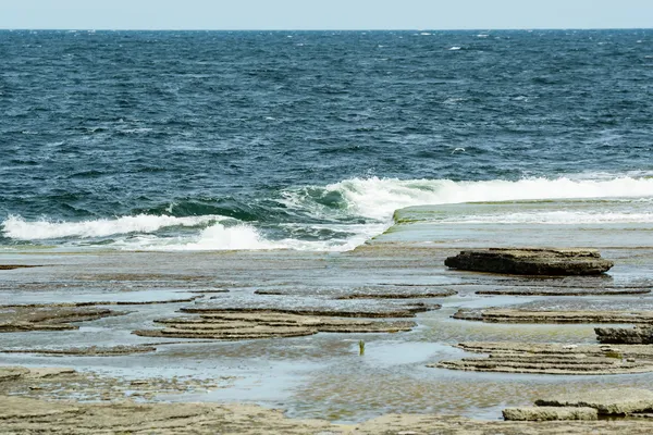 Waves on limetone beach — Stock Photo, Image