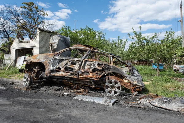 Burned and broken car. War in Ukraine 2022. Russian missiles in Kharkiv Ukraine. Russian aggression, conflict. Russian attack on Ukraine. Russia is bombing Ukraine
