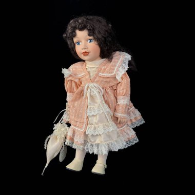 Siyah arka planda izole edilmiş porselen bebek. bağbozumu elbiseli seramik yaşlı bebek