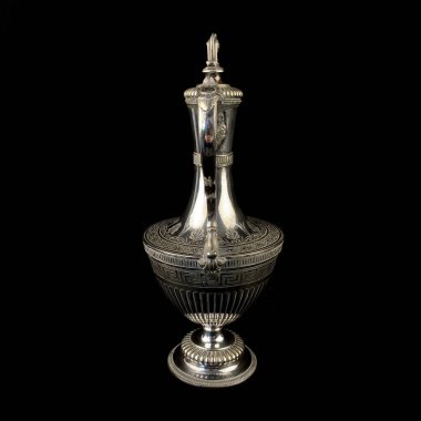 Üzerinde antik gümüş sürahi işlenmiş. Siyah izole arkaplanda çiçek desenli klasik metal oyması.