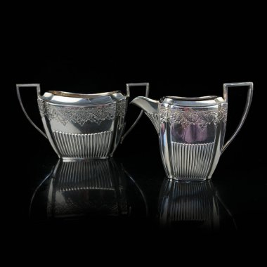 Siyah izole edilmiş arkaplanı olan gümüş antika servisi. Klasik çay servisi..