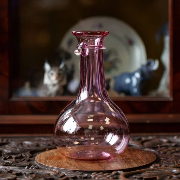 antique pink glass flower vase in the interior. pink vase for flowers in a luxury interior. luxury vase