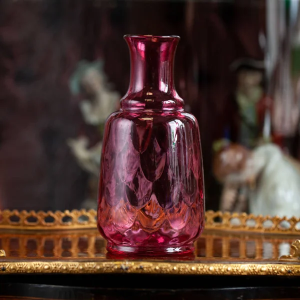 antique red glass flower vase in the interior. vase for flowers in luxury interior. luxury vase